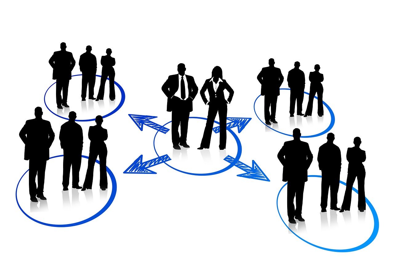 Silhouettes of professionals stand in interconnected blue circles with arrows, symbolizing teamwork, collaboration, and network dynamics.