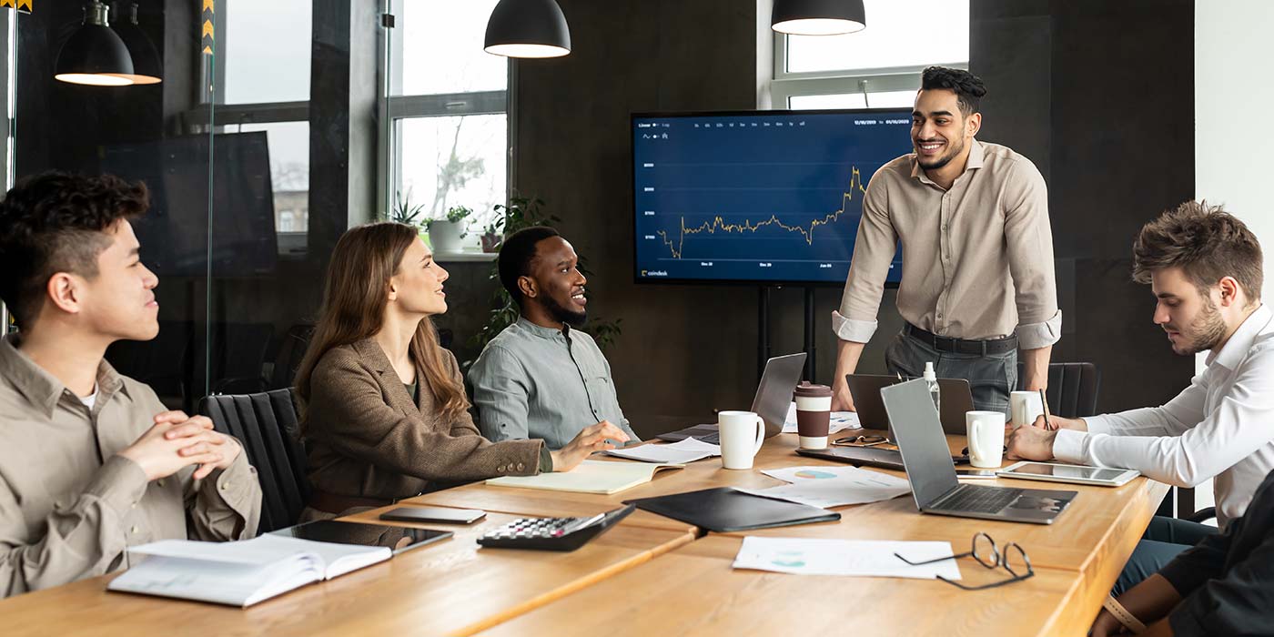 Study Business in Australia at a VET college in Adelaide, Brisbane, Melbourne or Sydney - group of colleagues in a board room with a chart in the background