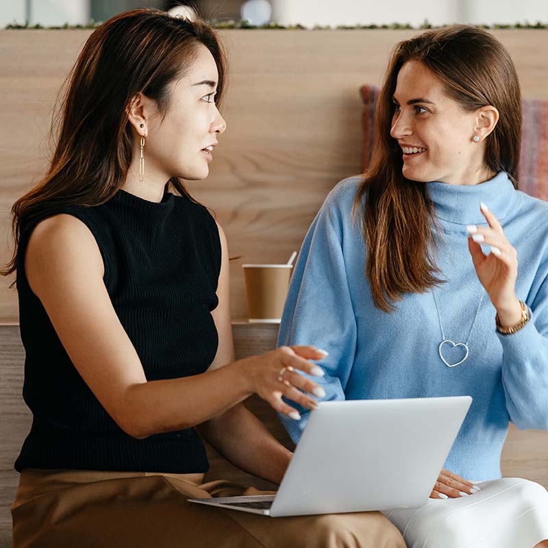 why study entrepreneurship - two women discussing a business idea in front of a laptop