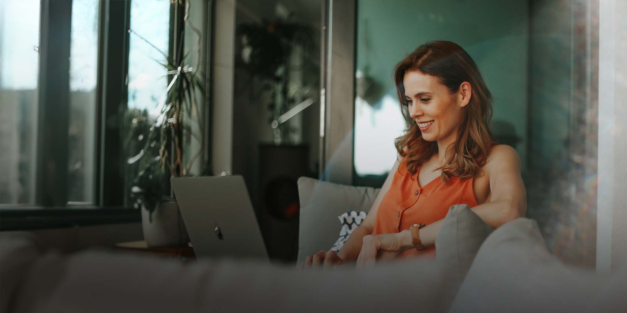 prepare for the TEF or TEFaQ test online - woman sitting on couch with laptop studying